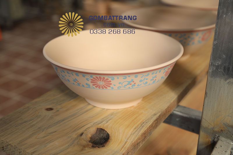 Bát đĩa gốm sứ Bát tràng được vẽ hoa văn trên gốm trước khi nhúng men và cho vào lò nung