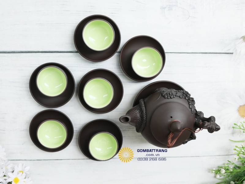 Từ góc nhìn trên cao, các chén xếp tròn quanh ấm như một tổng thể hài hòa. Tông màu nâu – xanh xen kẽ nhìn rất thư thái, hợp đặt trong không gian trà thất nhỏ hoặc góc phòng khách.